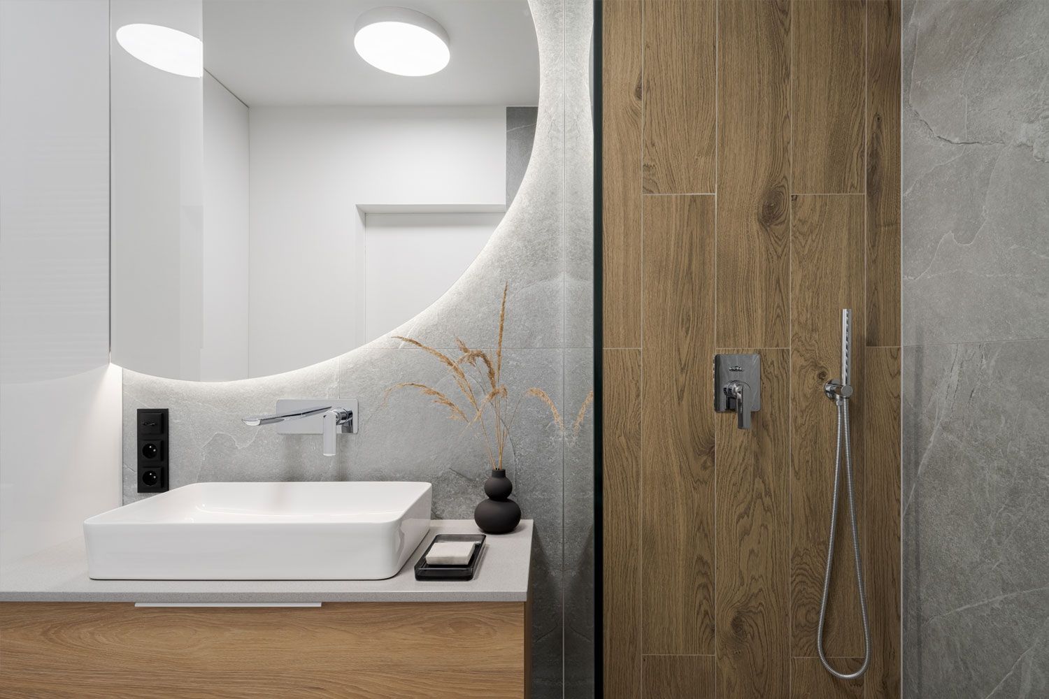 Contemporary moon shaped mirror with oak panelling in Redditch bathroom design