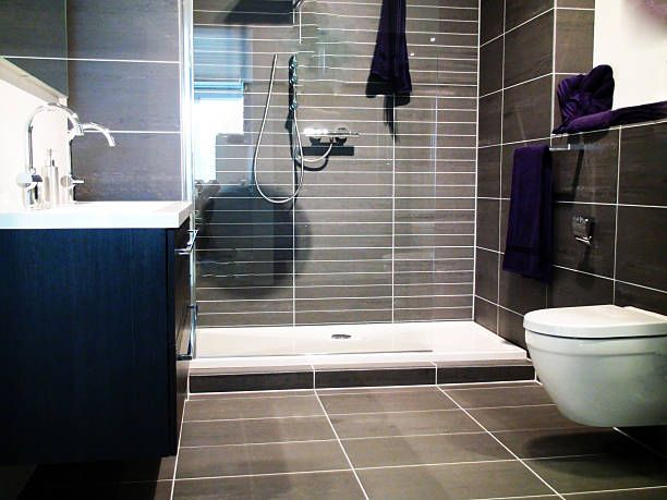 Brown and white wet room with chrome shower fitted by wet room specialists in Redditch