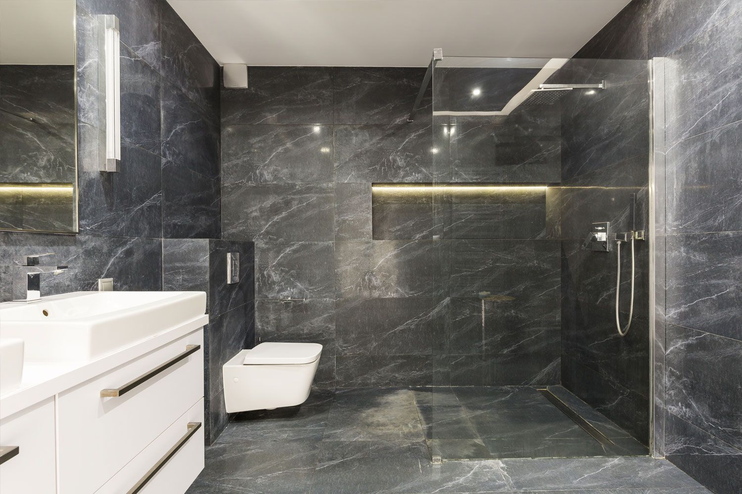 Luxury granite tiled bathroom with premium glass shower enclosure installed in Redditch